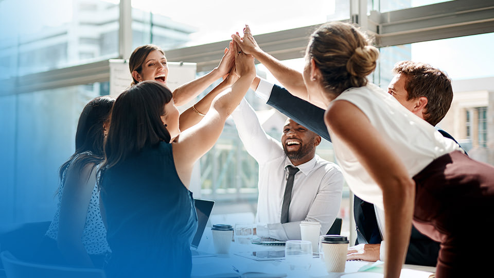 A business team high fiving