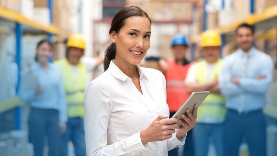 A supervisor standing in front of her warehouse crew